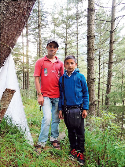 The authors field assistant Dipu and a village youngster, who took a keen interest in her work.